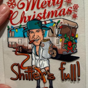 May include: A Christmas-themed graphic featuring a cartoon character in a bathrobe, holding a mug and cigar, standing in front of a decorated RV. The text reads "Merry Christmas" and "Shitter's full!" in red and orange.