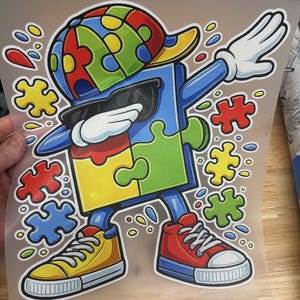 May include: A colorful graphic of a puzzle piece character dabbing, wearing sunglasses, a hat, and sneakers. The character is composed of puzzle pieces in various colors, with additional puzzle pieces scattered around.