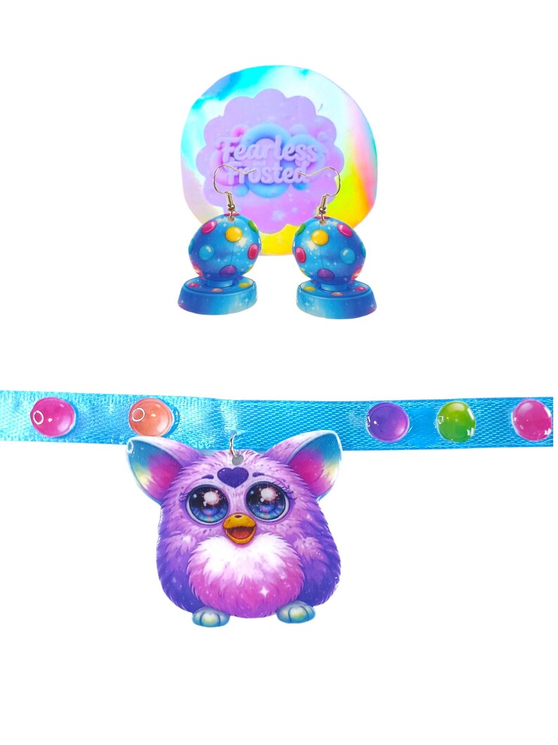May include: A set of colorful earrings and a necklace featuring a purple Furby pendant. The earrings have blue bases and dotted spheres. The necklace has a blue band with colorful bubble accents. The background features the text "Fearless Frosted".
