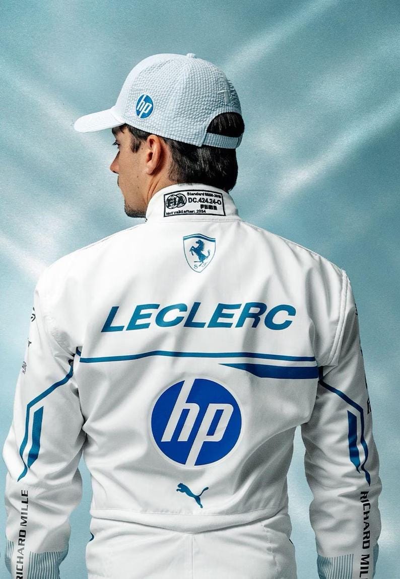 May include: A white racing jacket and cap featuring the HP logo in blue. The jacket has blue accents and the name "LECLERC" across the back. The Puma logo is visible below the HP logo.