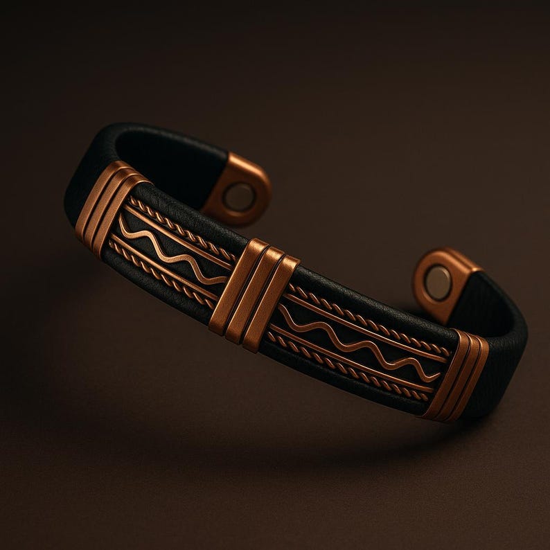 May include: Black leather cuff bracelet with copper-colored metal accents. The bracelet features a wave pattern and vertical bars. The ends of the bracelet have magnetic closures. A stylish accessory.
