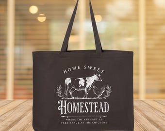May include: A dark brown tote bag with long handles. The bag features a white graphic of a cow and a chicken, with the words "Home Sweet Homestead" and "Where the kids are as free range as the chickens."