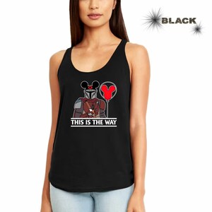 May include: Black tank top with a graphic of a Mandalorian character wearing Mickey Mouse ears and holding a red balloon. The text "This is the way" is printed below the graphic.