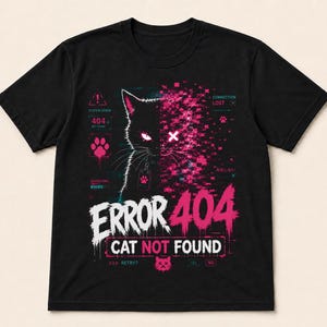 May include: A black short-sleeve t-shirt featuring a graphic of a cat with one side pixelated in pink. The design includes the text ERROR 404 CAT NOT FOUND, along with digital interface elements like system error icons, paw prints, and connection lost labels.