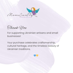 May include: A white card with a light purple brushstroke background featuring the MomsCanfly logo with a fairy illustration. The text reads: Thank You For supporting Ukrainian artisans and small businesses! Your purchase celebrates craftsmanship, cultural heritage, and the timeless beauty of Ukrainian traditions. A blue and yellow heart icon is at the bottom.