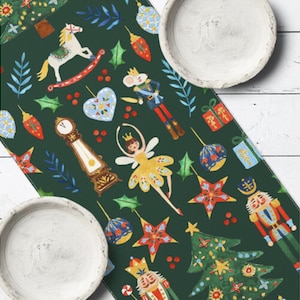 May include: A dark green Christmas table runner with festive illustrations. The design includes a rocking horse, a ballerina, a nutcracker, and a grandfather clock. The runner is decorated with stars, ornaments, and Christmas trees.
