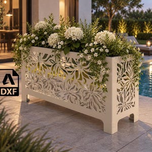 May include: A rectangular white metal planter featuring an intricate laser-cut floral pattern on its front and side panels. The planter is filled with white hydrangea flowers and trailing green foliage. A black square icon with the text DXF is visible.