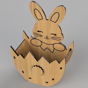 May include: Wooden Easter bunny rabbit figurine in an egg-shaped holder. The bunny has black eyes and a black nose. The egg is decorated with a flower design.