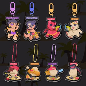 May include: Eight colorful acrylic keychains with different designs. The keychains feature a variety of characters including a person with a red hat and a white egg, a person with a yellow hat and a duck, a person with a red hat and a red egg, a person with a black hat and a brown egg, a red bear with wings, a white bear with wings, a person with a black bandana and sunglasses, and a person with a blue bandana and sunglasses. The keychains are all attached to silver chains.