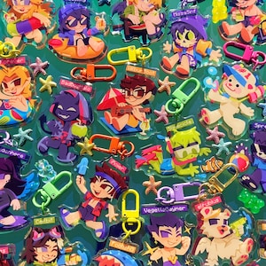 May include: A collection of colorful, cartoon character keychains with summer themes. The keychains feature characters with different hairstyles, clothing, and accessories. Some of the characters are holding items such as a watermelon, a surfboard, a popsicle, and a guitar. The keychains are made of clear plastic and have a shiny finish. The text on the keychains includes 'Forever', 'BadBoghalo', 'Milbur 300t', 'Slirecicle', 'Vegettabaymer', 'elfubius', '1', 'Spre', 'denhere', 'hojen', 'Cedbit', 'Footsha', 'Missa Sinf'. 