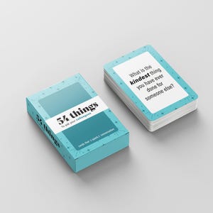 May include: A teal box and a stack of cards with the text "54 things to ask your colleagues" and "What is the kindest thing you have ever done for someone else?" The cards have a teal border and white background.