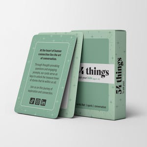 May include: A mint green card game box and cards with the text "54 things to ask your kids". The cards have text that reads "At the heart of human connection lies the art of conversation". The box and cards are on a white background.