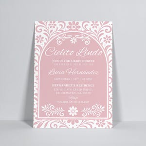 May include: A pink baby shower invitation with white floral and scrollwork border. The text "Cielito Lindo" is at the top, followed by details about the event, including the honoree's name, date, time, and location.