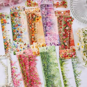 May include: Assortment of colorful floral patterned washi tape rolls with a variety of designs including flowers, vines, and fences. The tape is perfect for adding a touch of whimsy to crafts, journals, and scrapbooking.