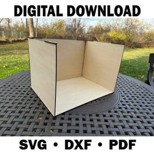 May include: A wooden box with black trim sits on a dark table. The box is open on one side and has a light wood grain finish. The words "DIGITAL DOWNLOAD" are at the top, and "SVG • DXF • PDF" are at the bottom.