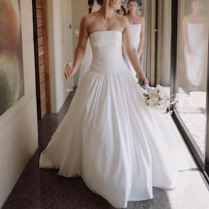Strapless Duchess Satin Drop Waist A-Line Sculpted Bridal Gown, Minimal Structured Bodice Contemporary Wedding Dress With Full Pleated Skirt