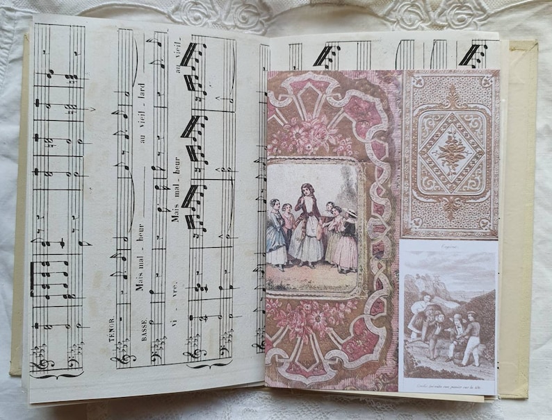 May include: An open vintage music book with a decorative paper cover. The cover features a pink and brown floral pattern with a gold border. The book is open to a page with sheet music and the words "Mais mal - heur" and "au vieil - lard" written in French.