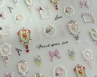 May include: Sheet of decorative stickers featuring ornate frames, bows, and floral designs in pastel colors. The stickers include text such as "Love" and "Plant spice set". The stickers are ideal for scrapbooking, card making, or other craft projects.