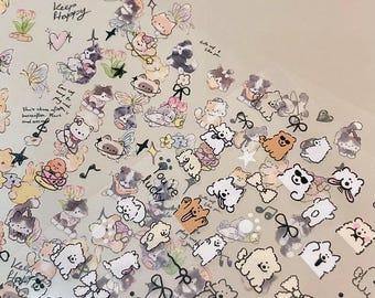 May include: A sheet of clear sticker paper with various cute cartoon animal stickers. The stickers feature dogs, cats, butterflies, flowers, and stars. The stickers have a white background with black outlines and colorful accents. The text "Keep Happy" and "You're Lucky" are included on the sheet.