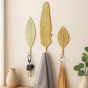 Gancho de pared de metal con hojas doradas – Decoración natural elegante