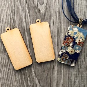 May include: Two blank wooden rectangular tags with a hole at the top and a blue and gold floral patterned rectangular tag with a metal loop at the top.