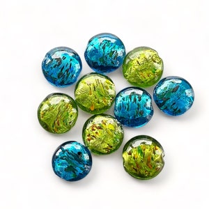 May include: A collection of ten round glass beads with a mottled blue and green pattern. The beads have a metallic sheen and are perfect for jewellery making.