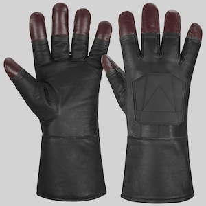 May include: Black leather gloves with burgundy fingertips. The gloves have a geometric design on the back of the hand and a long cuff. The gloves are made of a smooth, durable material.