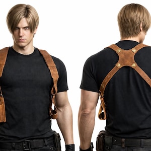 May include: Brown leather shoulder holster with two pouches and adjustable straps. The holster is worn over a black t-shirt. The image shows the front and back of the holster.
