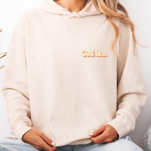 Retro &quot;God is...&quot; Hoodie | Minimal Christian Sweatshirt | Unisex Faith-Based Apparel | Neutral Beige Pullover | Inspirational Gift