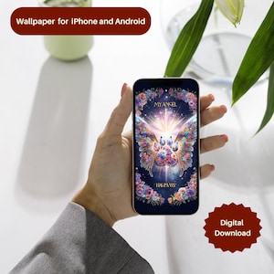 May include: A smartphone displays a digital wallpaper with a colorful butterfly design, a paw print, and the text "MY ANGEL HAS PAWS." The image is surrounded by floral accents and a dark blue background. The phone is held in a hand.