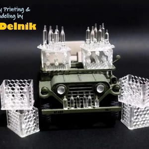 May include: A miniature olive green model jeep with clear plastic containers and small bottles. The containers are stacked and arranged around the jeep. The text "Happy Printing & Modeling by modelnik" is in the upper left corner.