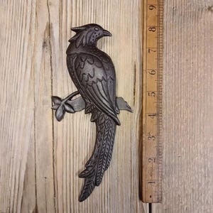 May include: A distressed wooden sign, inscribed with 'Welcome to our home' in white. The sign has a rustic appearance, ideal for a porch or hallway, and is designed with a simple, welcoming aesthetic.