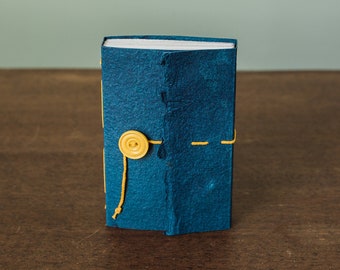 Small, sturdy notebook with blue cave paper and yellow accents