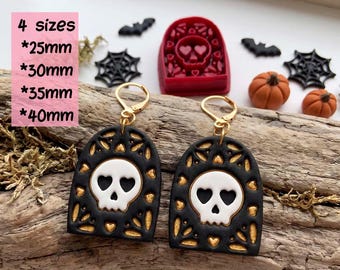 May include: A digital STL file for a clay cutter for earrings, featuring a red arch-shaped cutter with a skull design. The set includes four sizes: 25mm, 30mm, 35mm, and 40mm. The earrings are black with gold accents and a white skull.