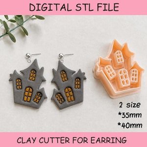 May include: A digital STL file for a clay cutter shaped like a haunted house, accompanied by two finished gray house-shaped earrings with orange windows. The cutter is peach-colored and includes text indicating two sizes of 35mm and 40mm.