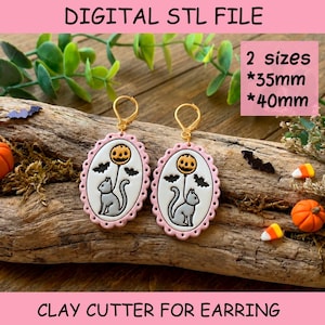 May include: A pair of oval-shaped clay cutters for earrings featuring a gray cat holding a pumpkin balloon with bats. The text reads DIGITAL STL FILE, 2 sizes, 35mm, 40mm, and CLAY CUTTER FOR EARRING. The cutters have a scalloped pink border.