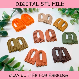 May include: A collection of arch-shaped clay cutters for earrings in various colors including orange, beige, mustard, olive green, terracotta, and brown. Each cutter features a textured striped pattern and a scalloped base. Text reads DIGITAL STL FILE.