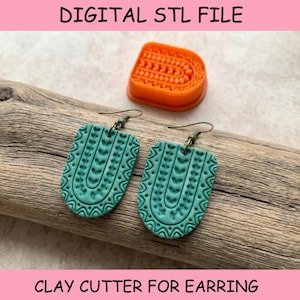 May include: A pair of teal earrings with a textured arch pattern and bronze-toned hooks, accompanied by an orange plastic arch-shaped clay cutter. The text DIGITAL STL FILE and CLAY CUTTER FOR EARRING is visible in the image.
