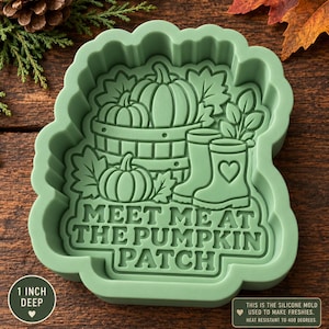 May include: A light green silicone mold featuring a raised design of pumpkins in a basket, autumn leaves, and rain boots with a heart detail. The text reads "MEET ME AT THE PUMPKIN PATCH". The mold is 1 inch deep and heat resistant to 400 degrees.