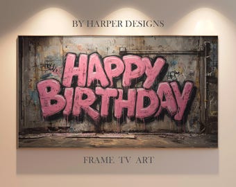 Op de afbeelding: Een ingelijst kunstwerk met de woorden "HAPPY BIRTHDAY" in grote, roze graffiti letters. De achtergrond is een verweerde muur met graffiti en verfspatten, wat een street art uitstraling geeft. Het kunstwerk is gelabeld "FRAME TV ART".