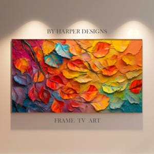 May include: A rectangular framed artwork with a vivid autumn leaf design. The leaves are painted in a thick impasto style, displaying a palette of red, orange, yellow, and blue. The text "BY HARPER DESIGNS" and "FRAME TV ART" are visible.