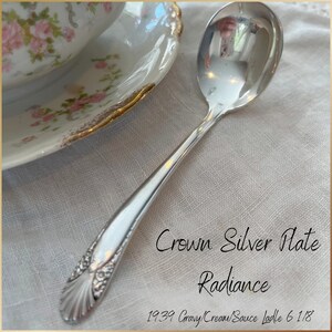 May include: Silver plated gravy ladle with a shell design on the handle. The ladle is 6 1/8 inches long and is marked "Crown Silver Plate Radiance 1939".