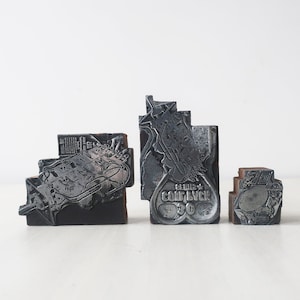 Vintage trio of A.I.S. metal wooden printing blocks