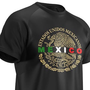 May include: Black t-shirt featuring a gold emblem of the Mexican coat of arms. The emblem includes an eagle with a snake in its beak, surrounded by the words "ESTADOS UNIDOS MEXICANOS" and the word "MEXICO" in green, white, and red.