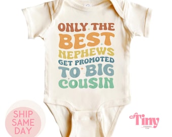 May include: A cream colored baby onesie with a rainbow colored graphic that reads "Only the best nephews get promoted to big cousin".
