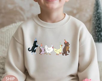 May include: A beige sweatshirt featuring a line of cartoon animals wearing party hats. The animals include a black and white cat, an owl, a white chicken, a yellow duck, and a brown bear. The word "NATURAL" is in the top left corner.
