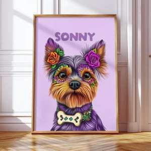 May include: A framed portrait of a Yorkshire Terrier with colourful floral and decorative accents. The dog's name, "SONNY", is displayed above. The dog wears a bone-shaped pendant and floral embellishments.