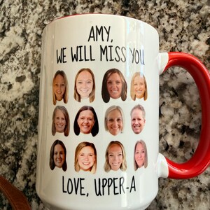 May include: A white ceramic mug with a red handle featuring a grid of twelve individual headshot photographs of people. The text at the top reads AMY, WE WILL MISS YOU and the text at the bottom reads LOVE, UPPER-A in black sans-serif font.
