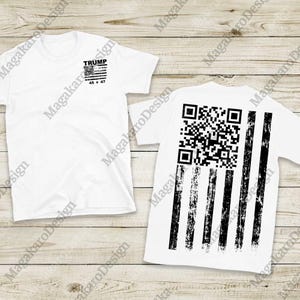 May include: White t-shirts with a black and white American flag design. One shirt features the word "TRUMP" and "45 * 47" on the front. The back of the other shirt displays a QR code and distressed stripes.