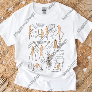 May include: White t-shirt with a quirky cartoon design. The illustration shows stick figures in different poses, each with speech bubbles. Phrases include "Robert Help" and "You're Ruining the Vibe".